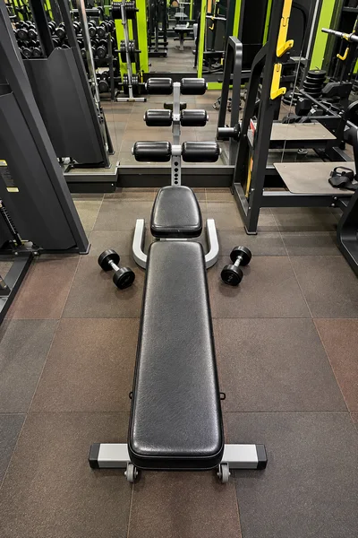 Core conditioning decline bench with dumbbells at Power House Gym Kolhapur