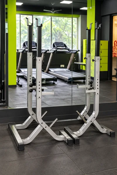 Adjustable Olympic squat stands with safety spotter arms at Power House Gym Kolhapur