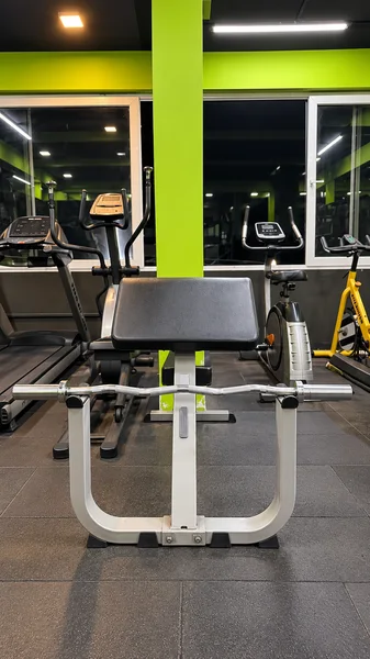 Preacher curl bench with Olympic EZ barbell at Power House Gym Kolhapur